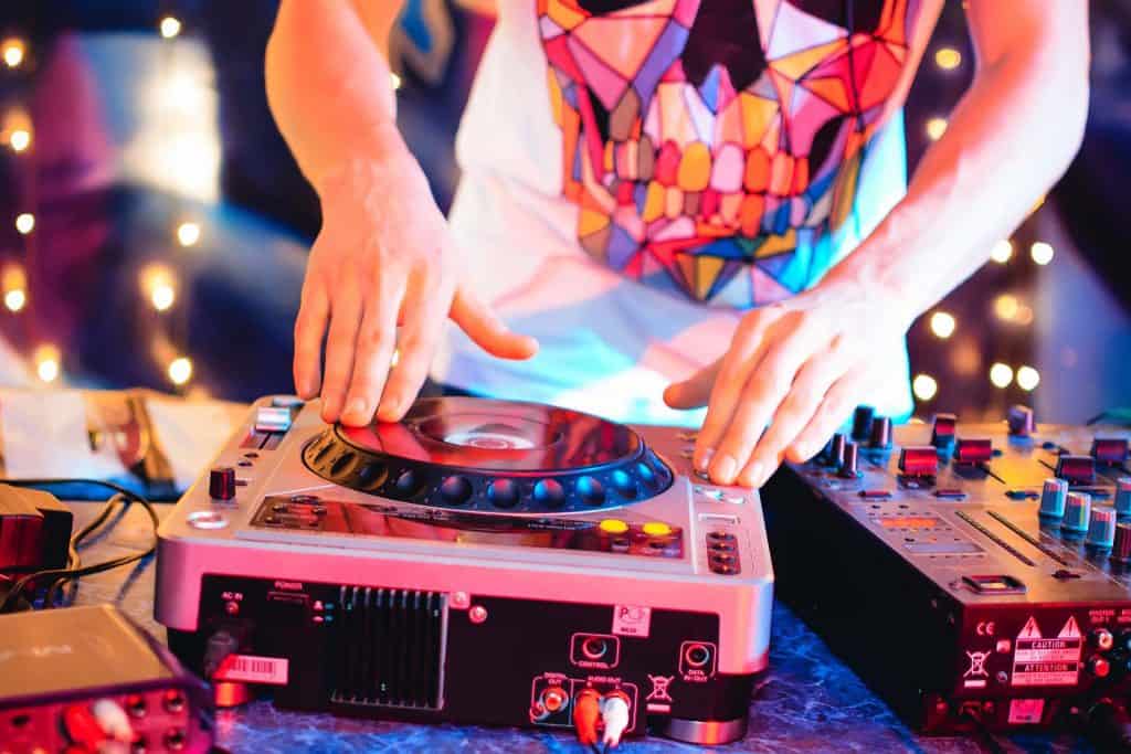 DJ in night club brings music to console